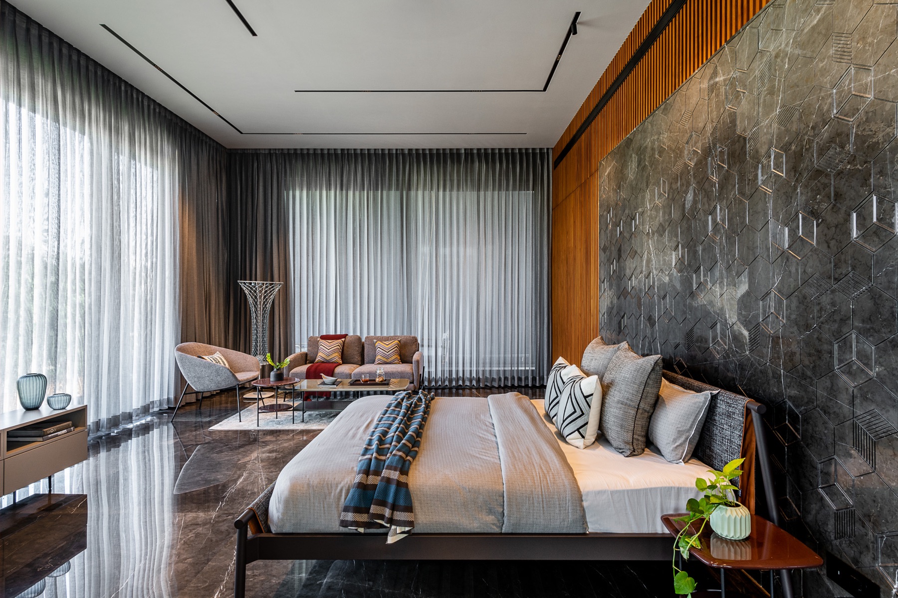 G.R. Asodaria bedroom with geometric stone feature wall