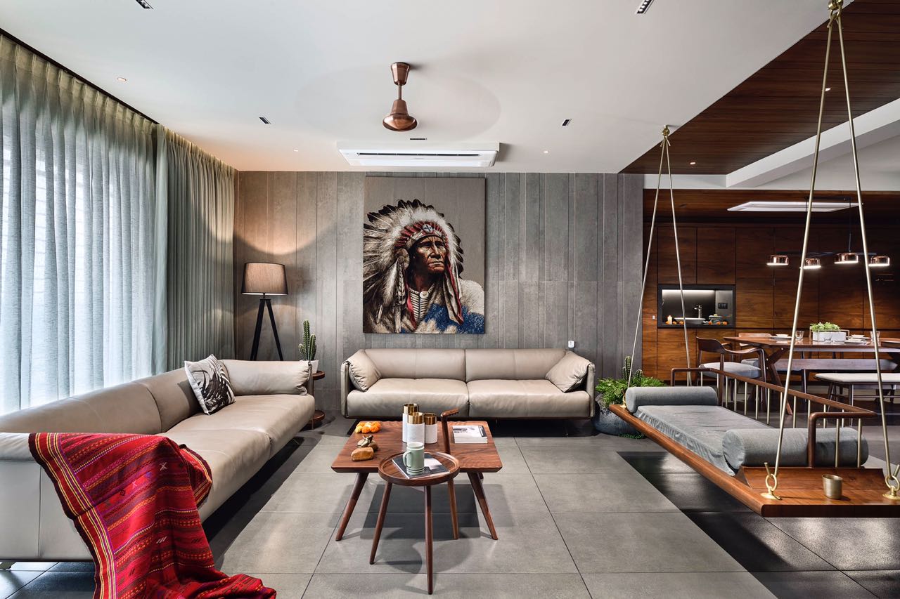 MA HOME living room with two leather sofas, chief portrait artwork and a timber swing