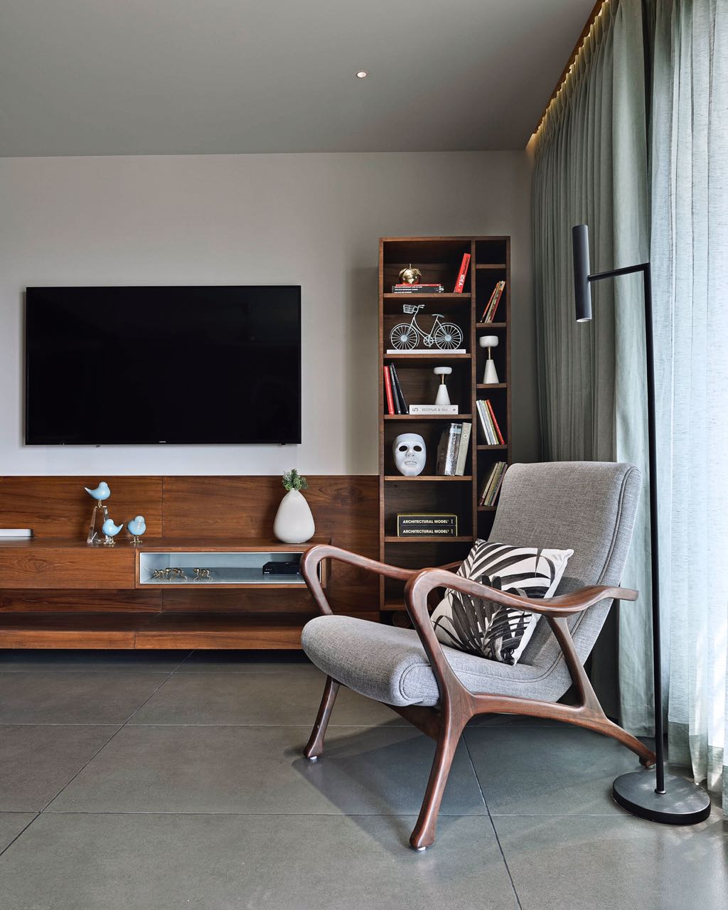 MA HOME teak media console with bookshelf, sculpted lounge chair and floor lamp