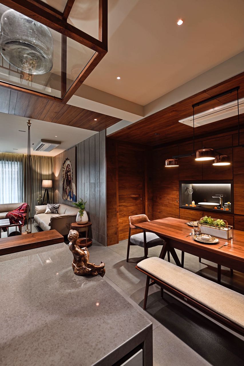 MA HOME walnut dining table with copper pendants, kitchen counter and living room beyond