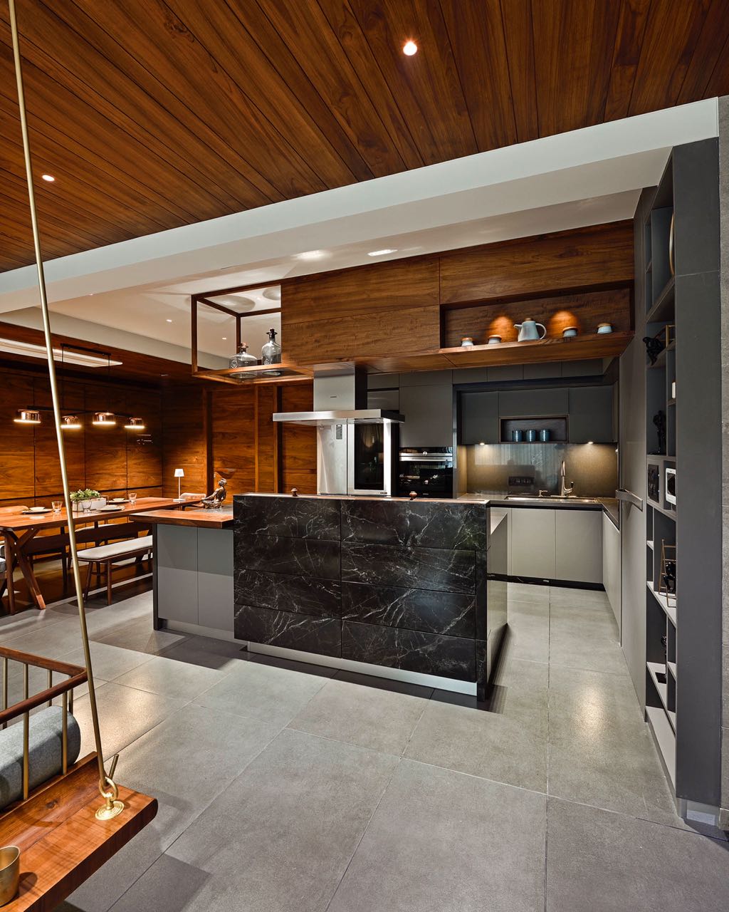 MA HOME kitchen with black marble island, grey cabinetry and timber-clad ceiling
