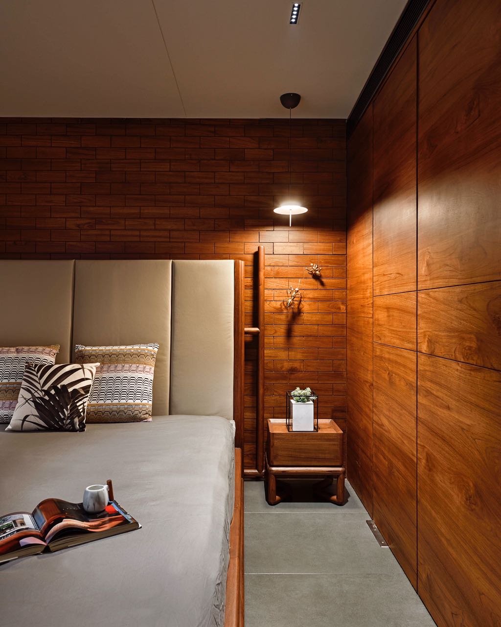 MA HOME bedside with teak brick-pattern wall, pendant light and timber nightstand