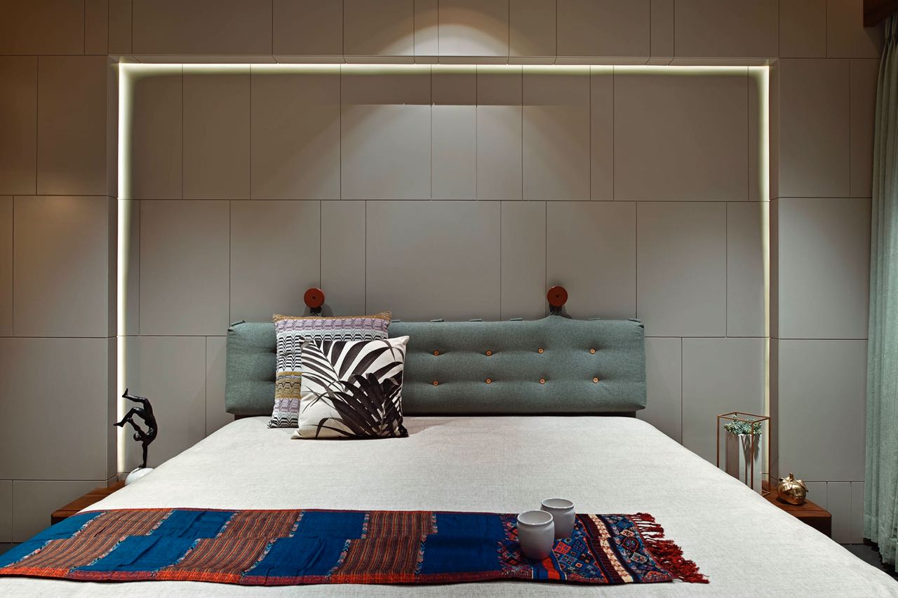 MA HOME guest bedroom with an illuminated frame around a buttoned fabric headboard