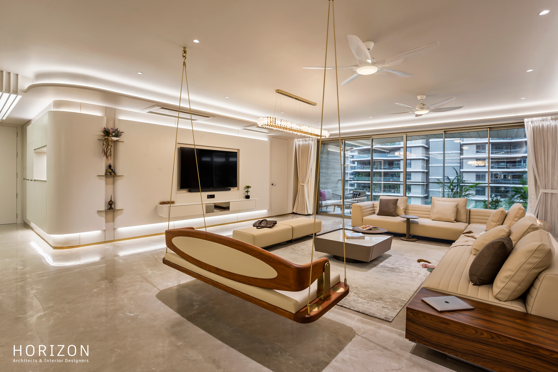 RAHUL BHAI HOME living room with brass-roped timber swing, sectional sofa and full-height windows onto the city