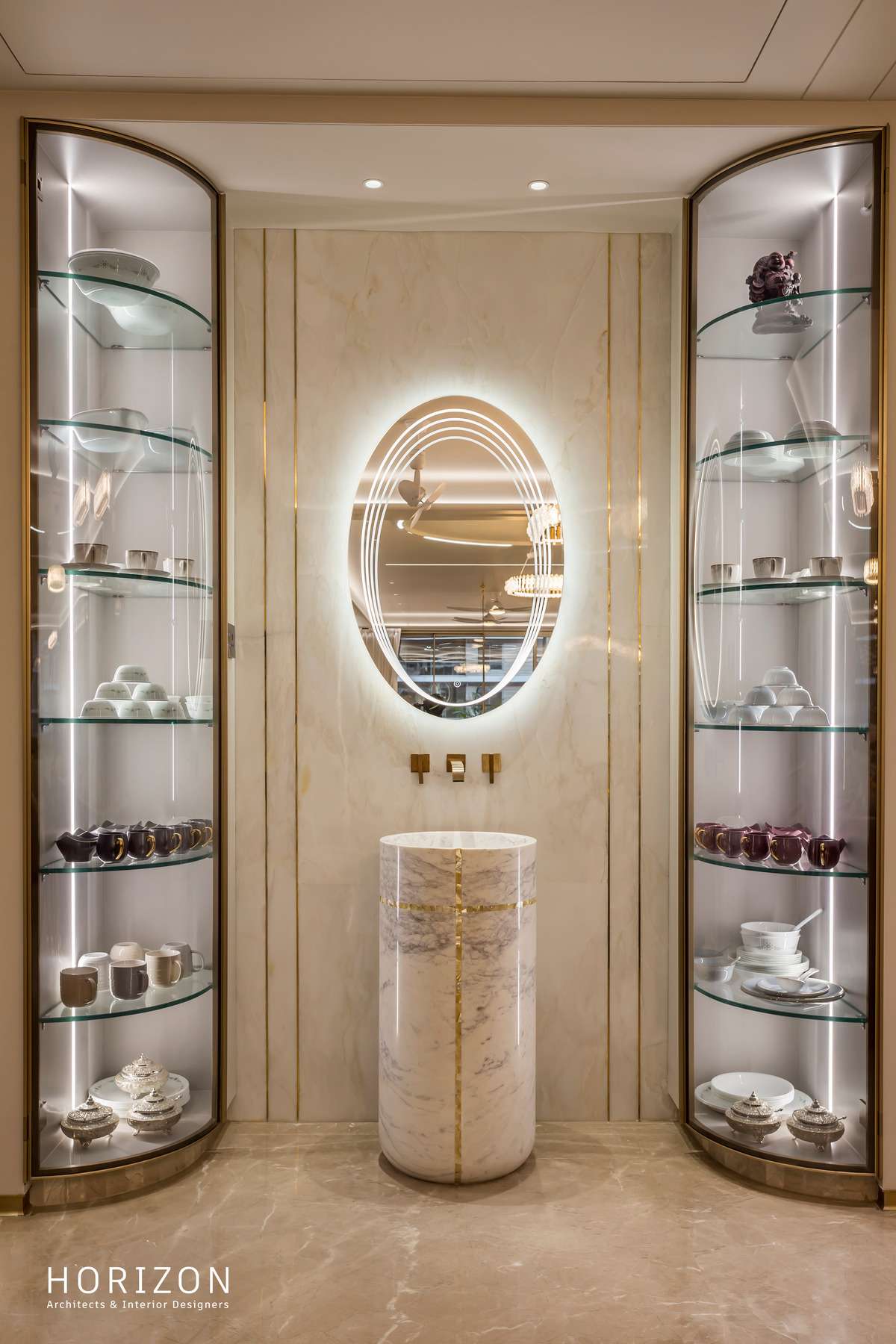 RAHUL BHAI HOME curved glass crockery display with lit shelves, oval mirror and marble pedestal