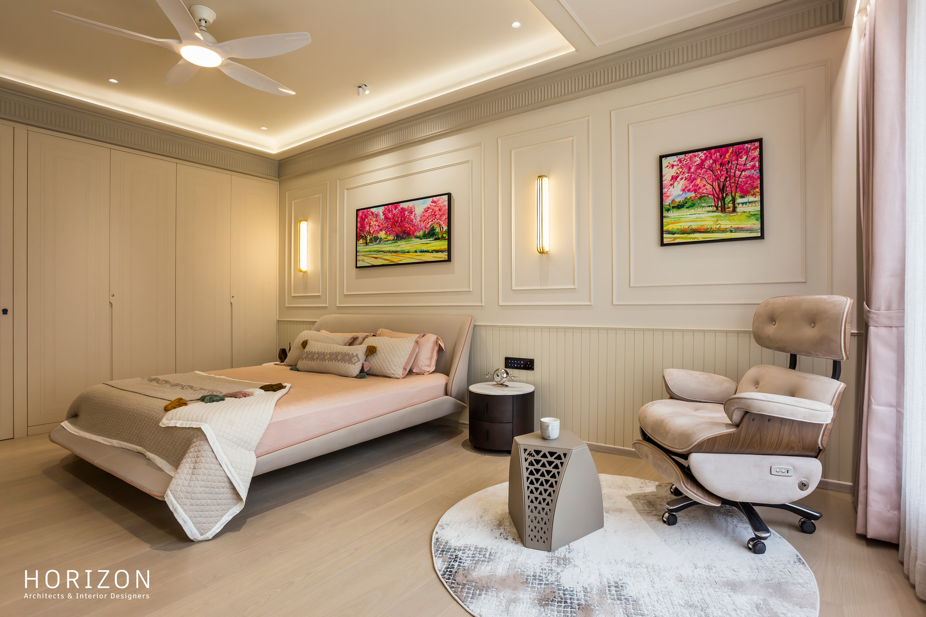 RAHUL BHAI HOME primary bedroom with panelled walls, wall sconces, blossom artwork, bed and leather recliner