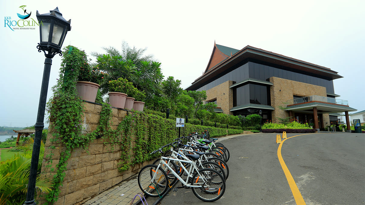Clubhouse arrival with bicycles and planted stone wall