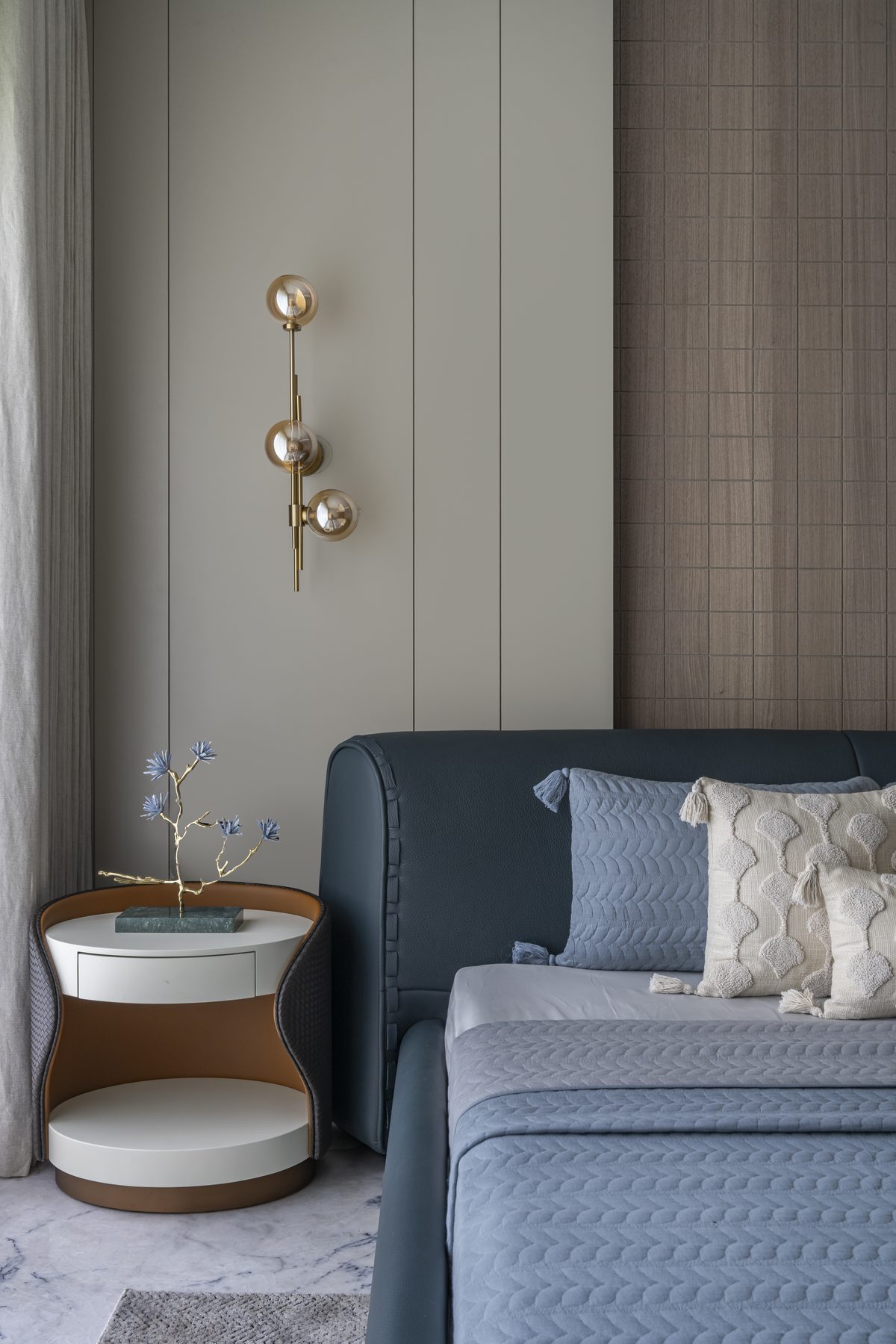 SACHIN BHAI HOME blue bedroom bedside with sconce and gold-branch sculpture