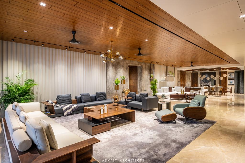VILLASHBHAI HOME living area with planting, rocking chair and a long timber ceiling