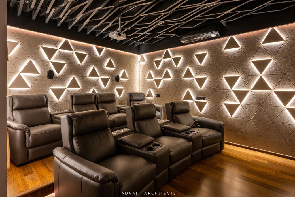 VILLASHBHAI HOME home theatre wall of lit triangles above leather recliners