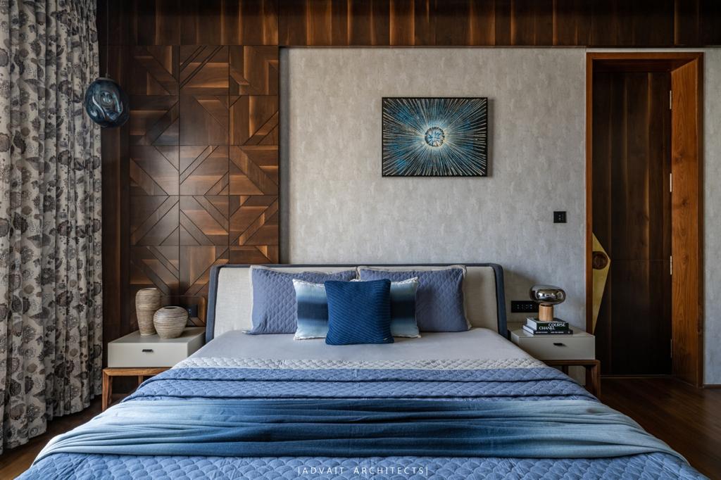 VILLASHBHAI HOME blue bedroom with patterned timber panelling and a wide upholstered headboard