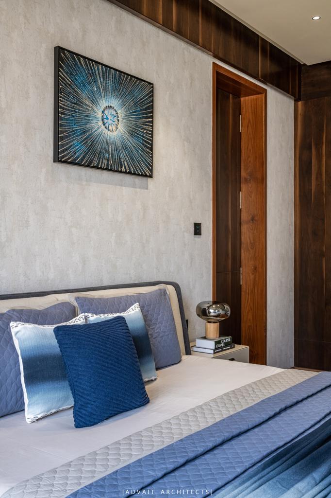 VILLASHBHAI HOME bedside with starburst artwork above textured wall panelling